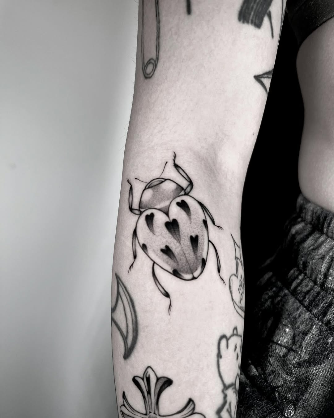 Charming black and white ladybug tattoo design