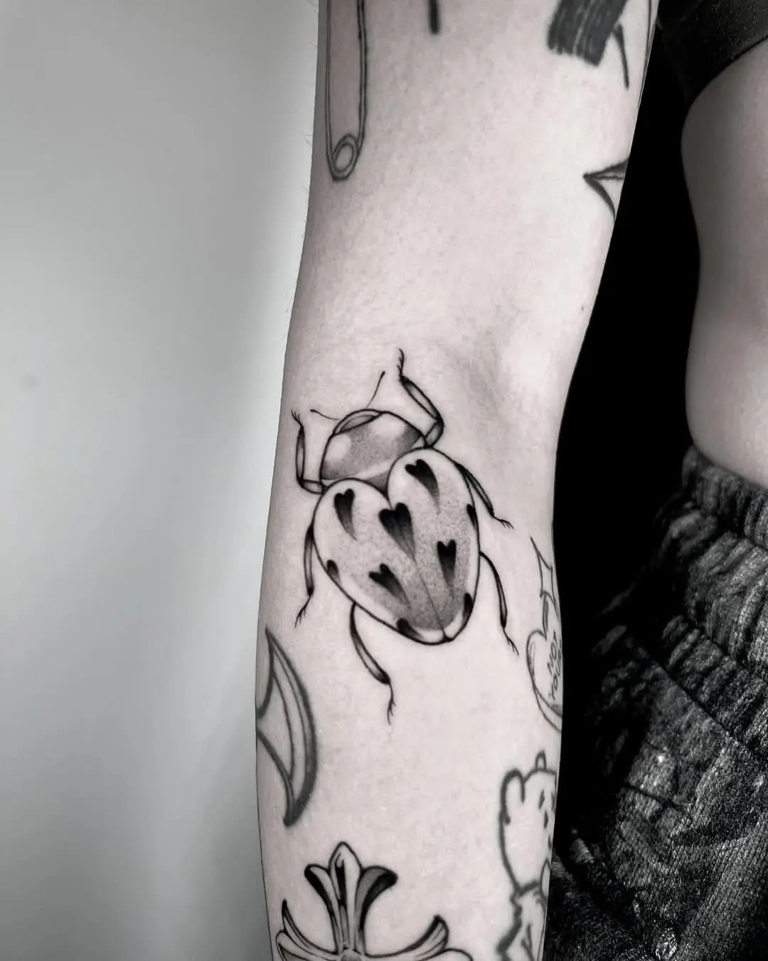 Charming black and white ladybug tattoo design