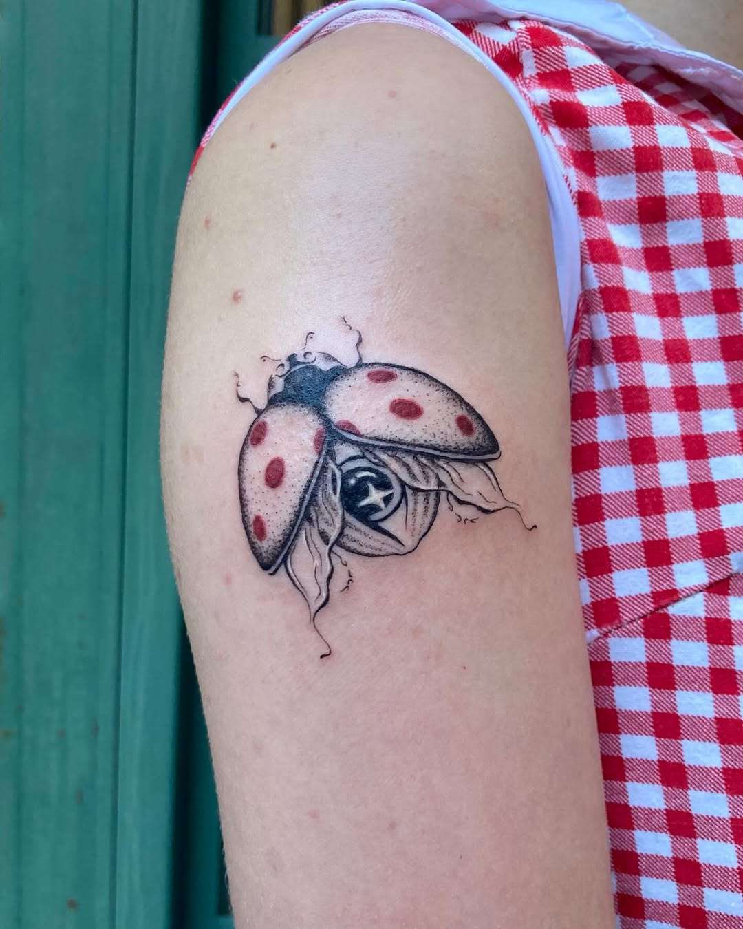 Charming ladybug tattoo with striking details