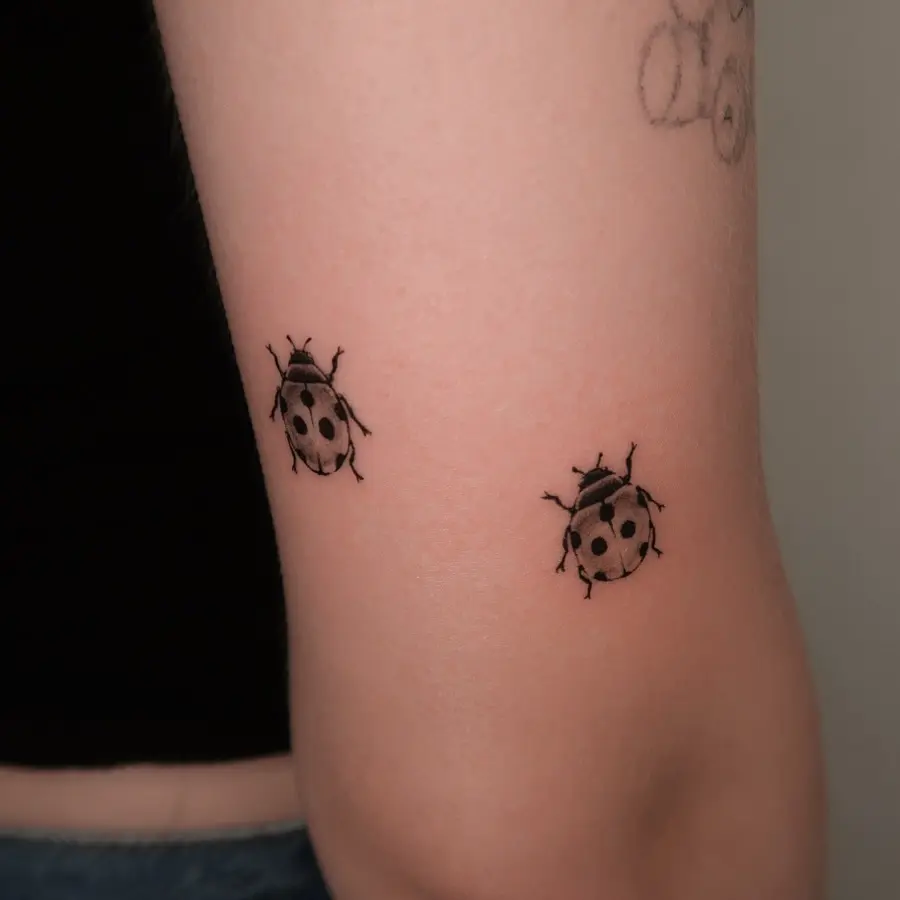 Charming minimalistic ladybug tattoo design