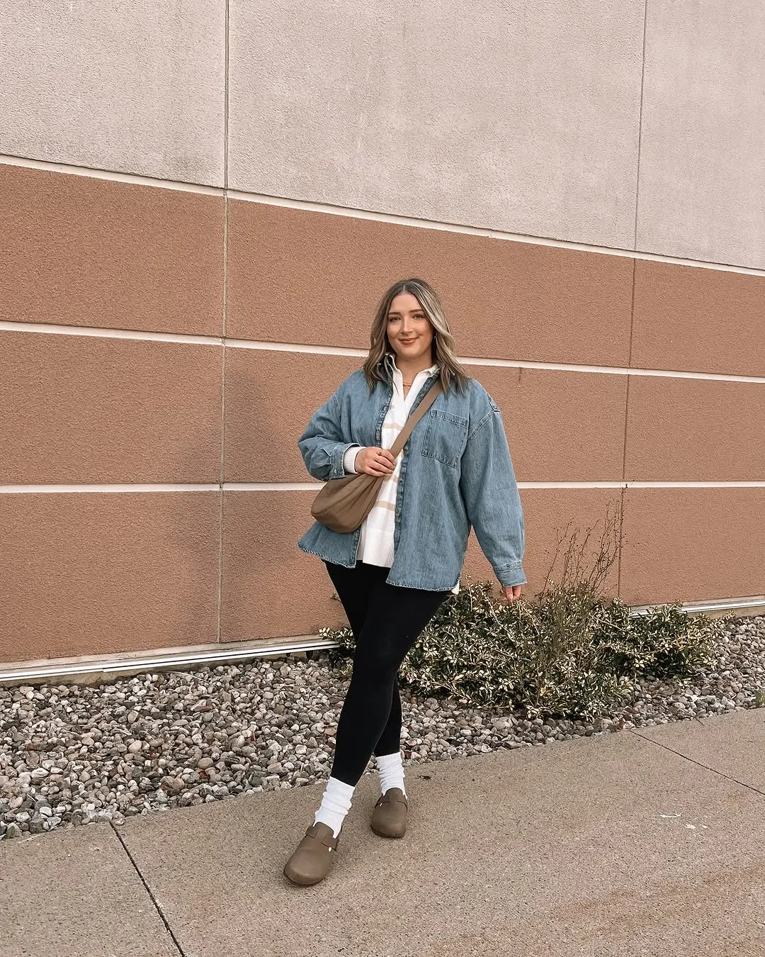 Casual chic with leggings and a denim jacket.