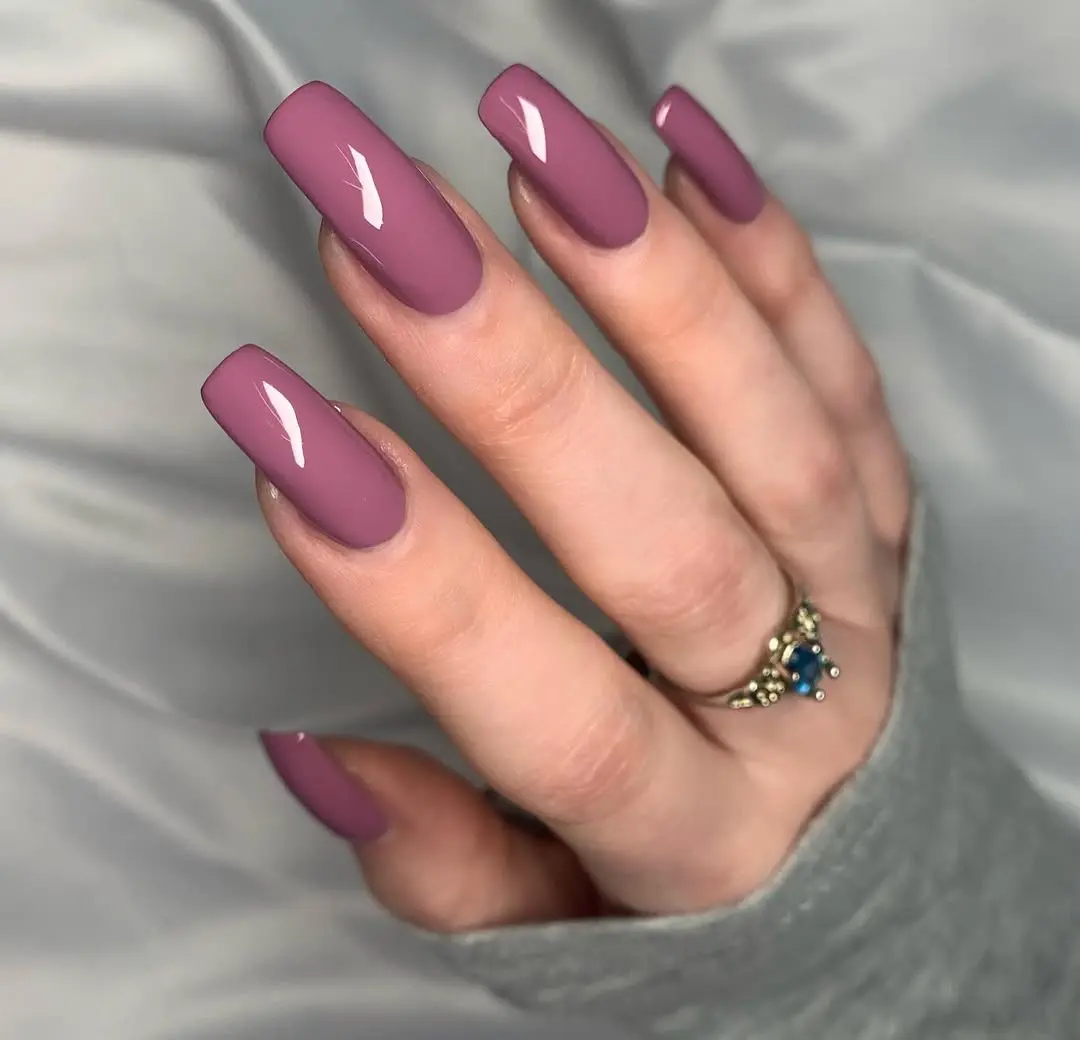 Stylish mauve glossy nails on long fingers
