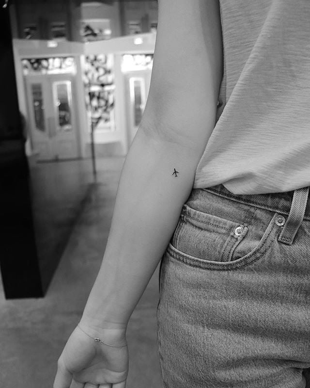Elegant airplane tattoo on the forearm