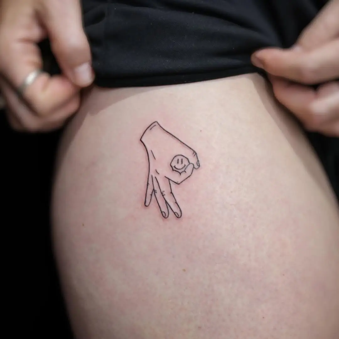 Cute hand gesture tattoo radiates positivity