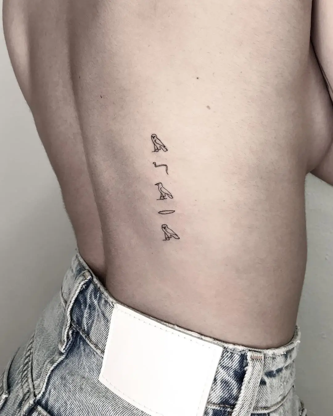 Unique minimalist Egyptian script tattoo design