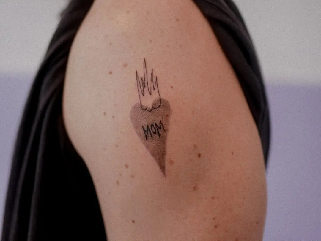 Flame-inspired heart tattoo honoring mothers