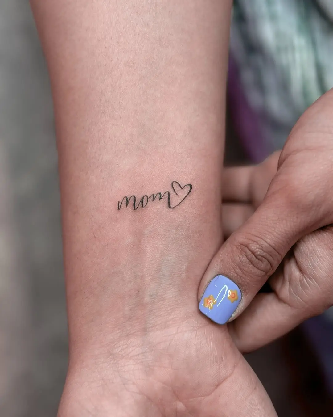 Elegant mom tattoo with a heart detail