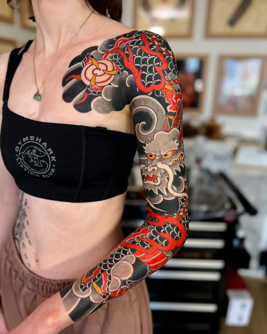 Intricate dragon and koi tattoo design on arm