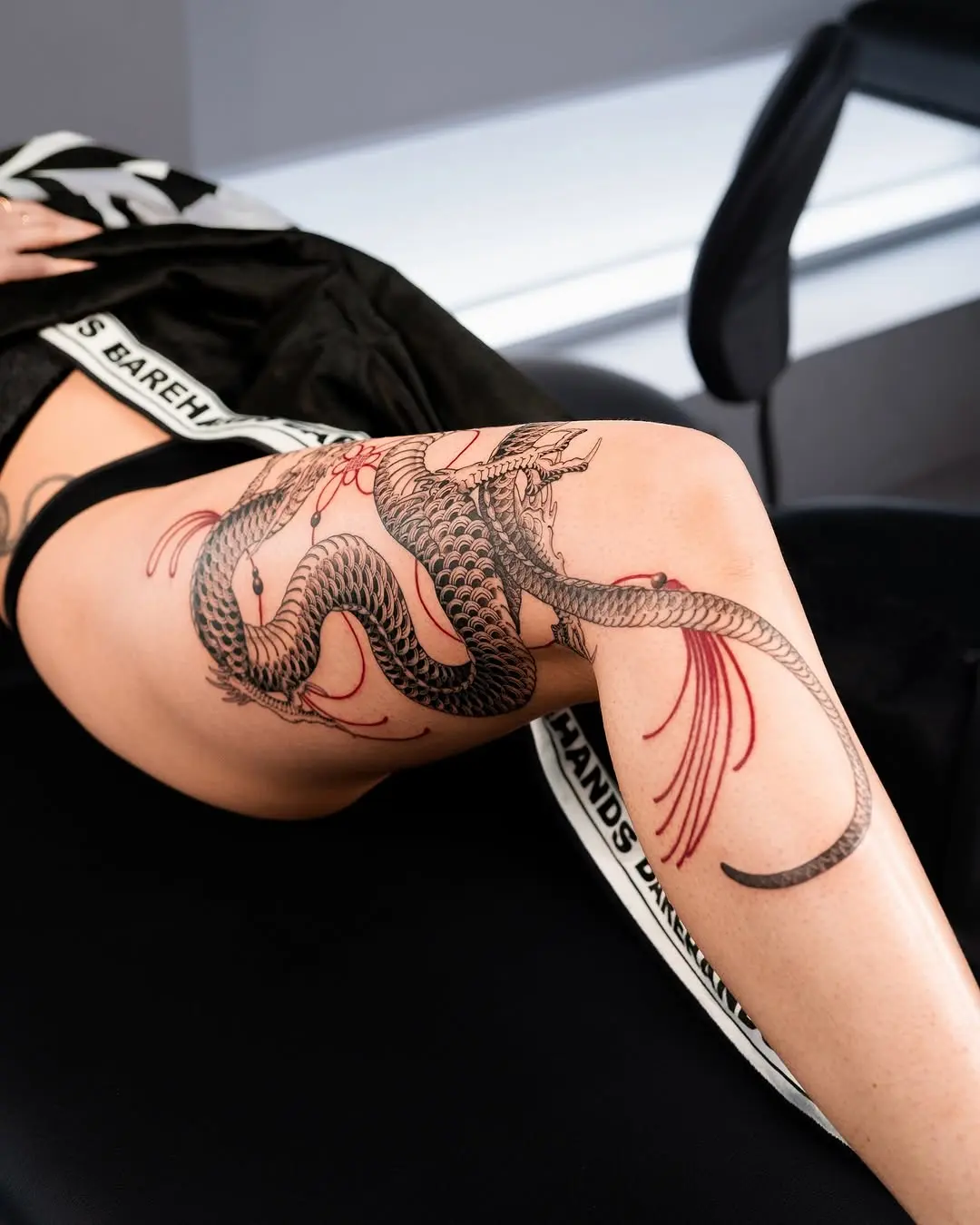Stunning dragon tattoo wrapping the leg elegantly