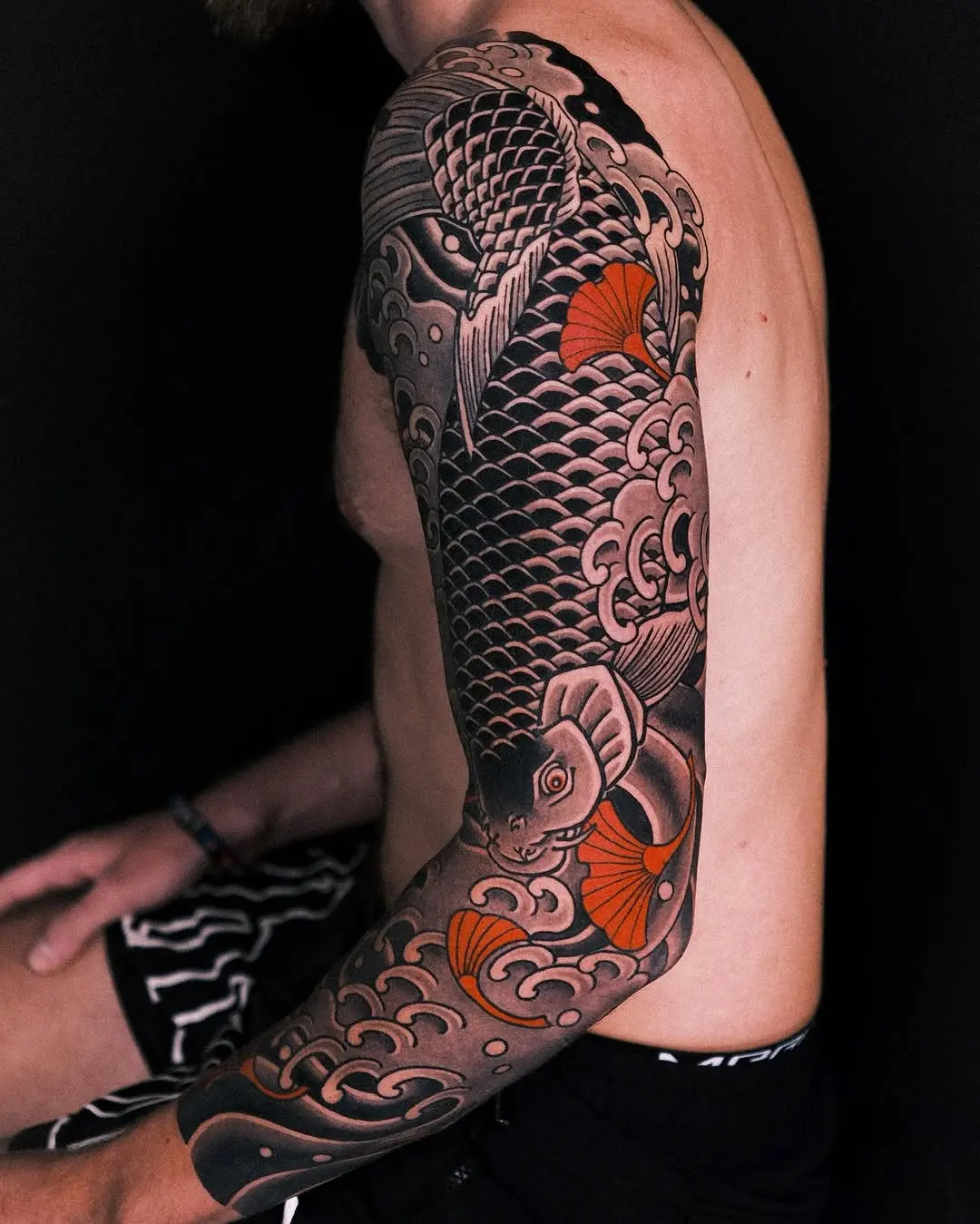 Elegant koi fish tattoo with wave motifs