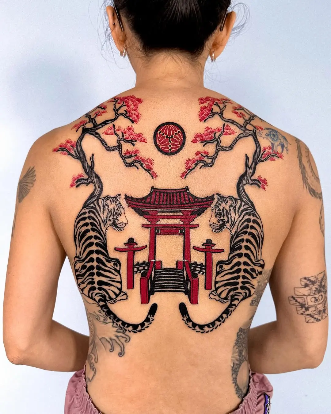 Striking Back Tattoo Featuring Tigers and Pagoda