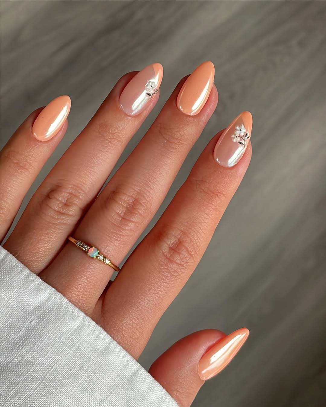 Chic peach nails with elegant floral accents