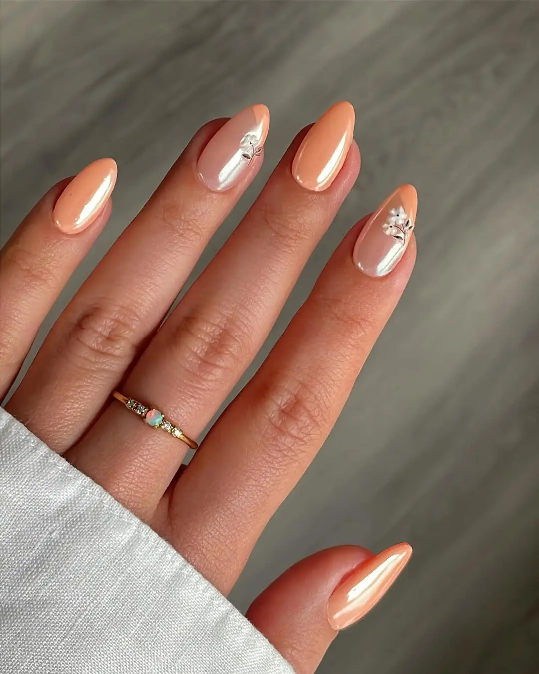 Chic peach nails with elegant floral accents