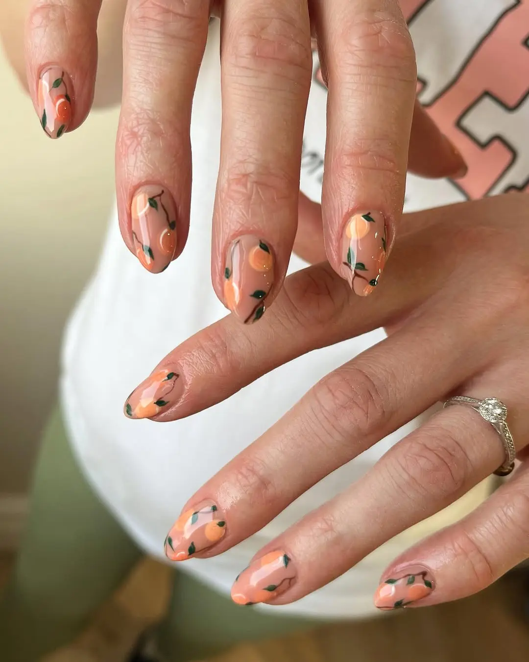Charming peach nails with delicate floral accents