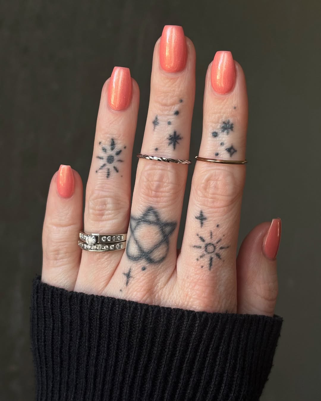Vibrant peach nails with celestial designs