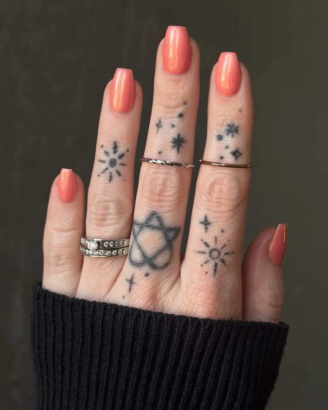 Vibrant peach nails with celestial designs