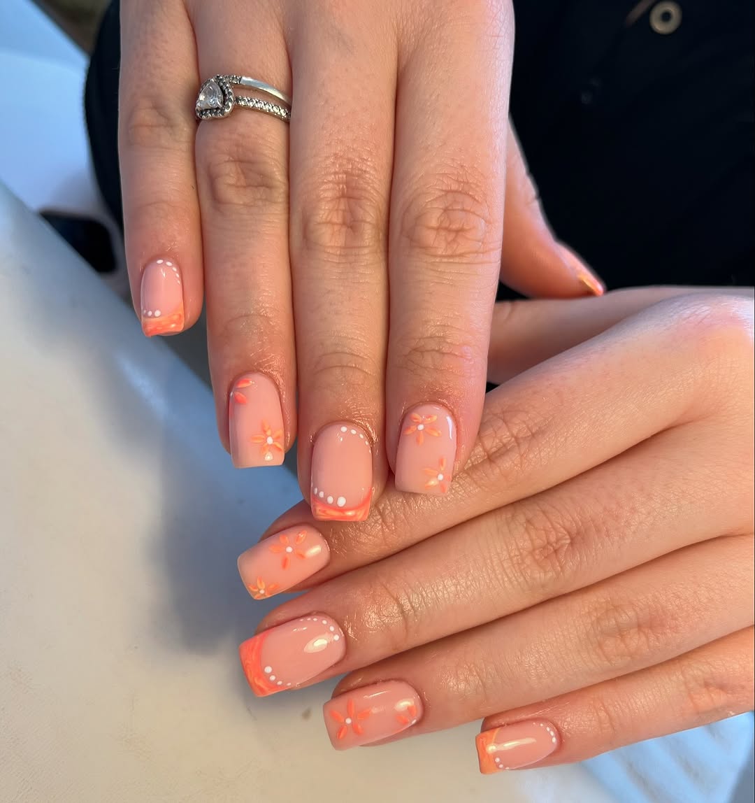 Charming peach nails with delicate flower accents