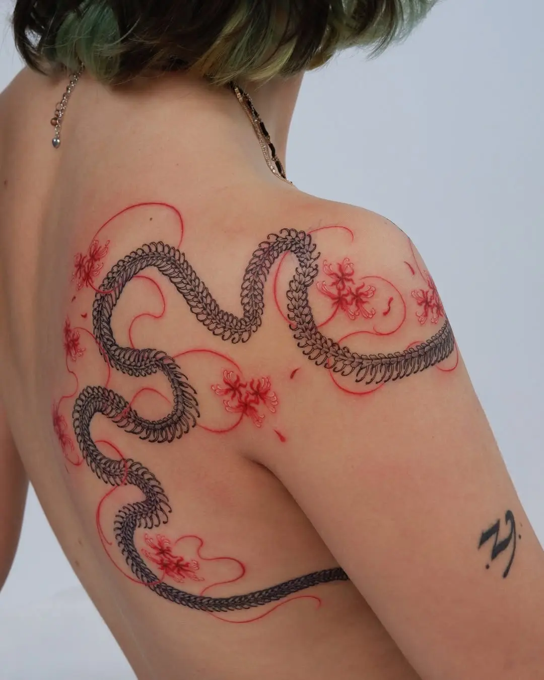 Intricate snake tattoo with floral elements