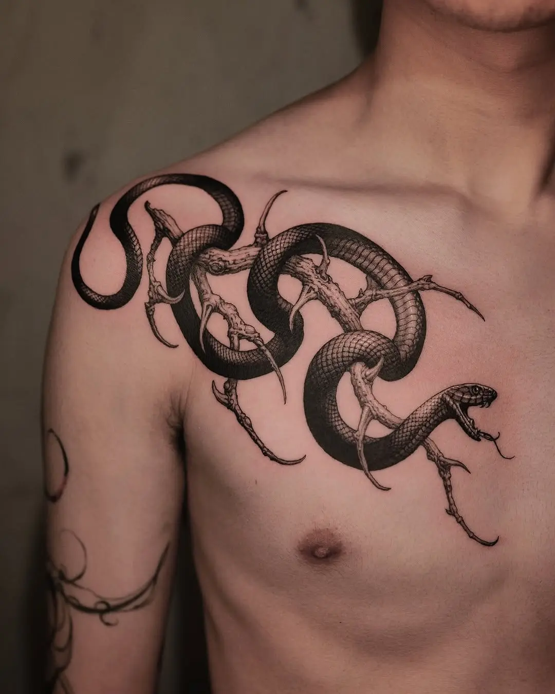 Intricate snake tattoo evolving on chest