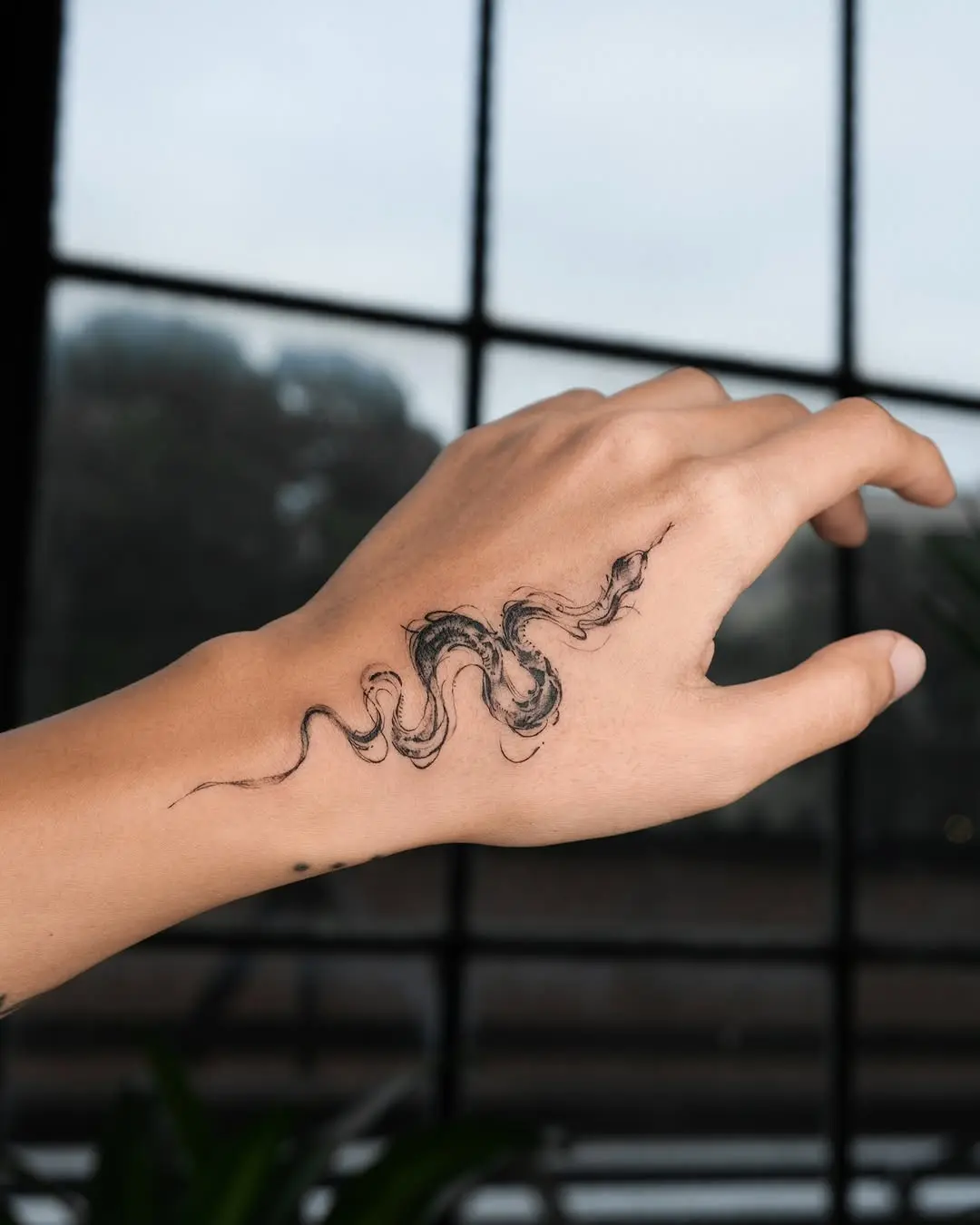 Intricate Snake Tattoo on Hand for Unique Style