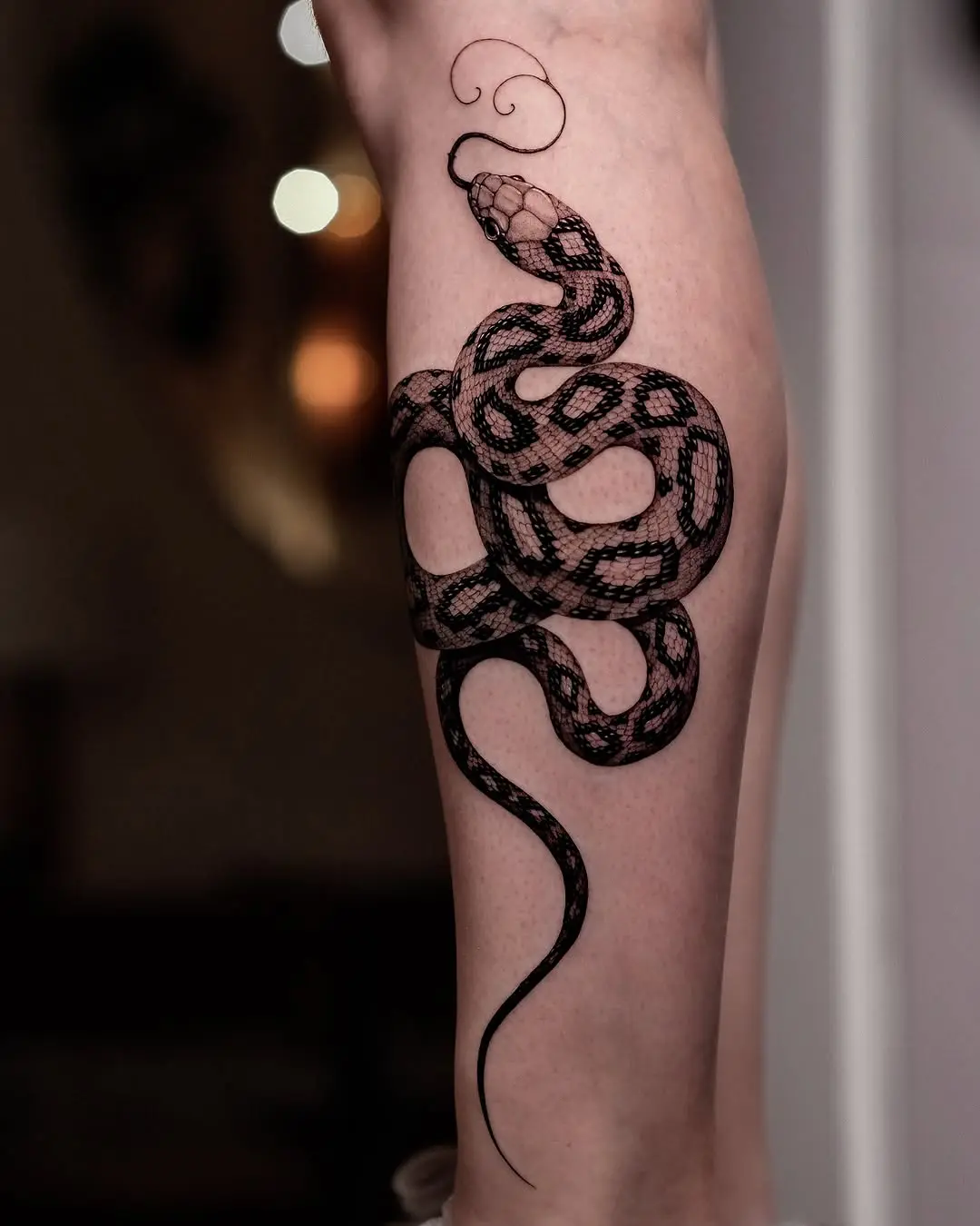 Intricate snake tattoo with ornamental flair