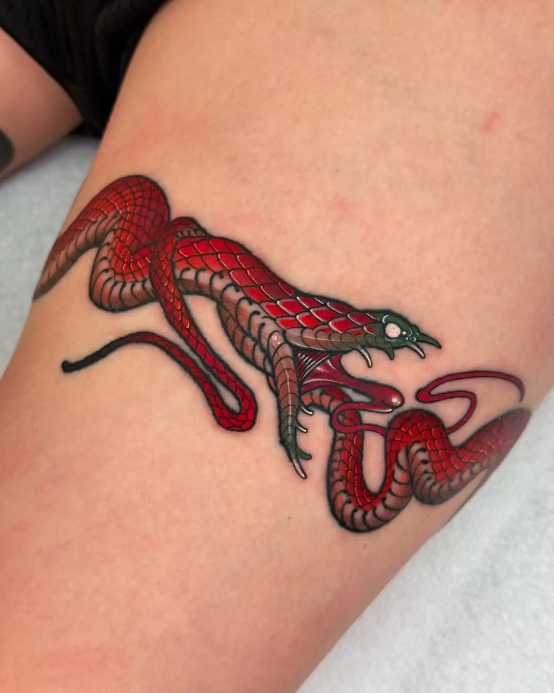 Striking red and black snake tattoo design