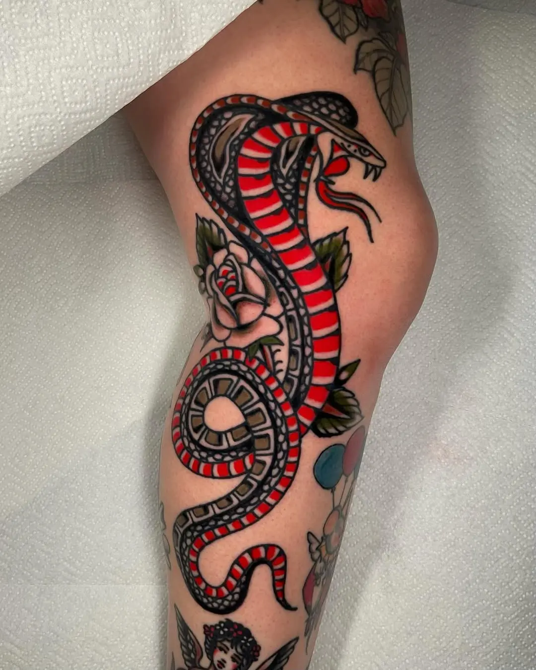 Bold snake tattoo with red and black design