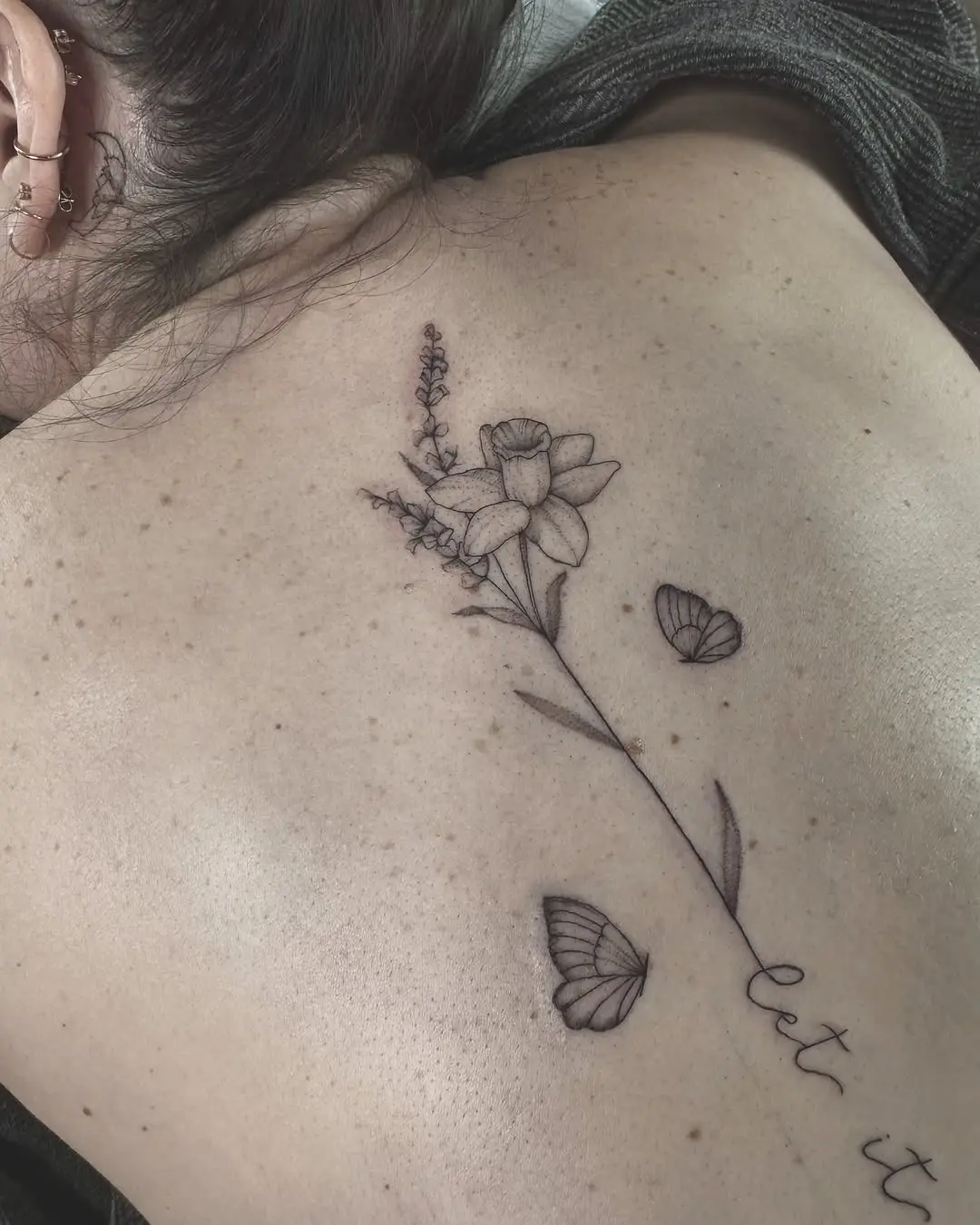 Elegant floral spine tattoo with butterflies