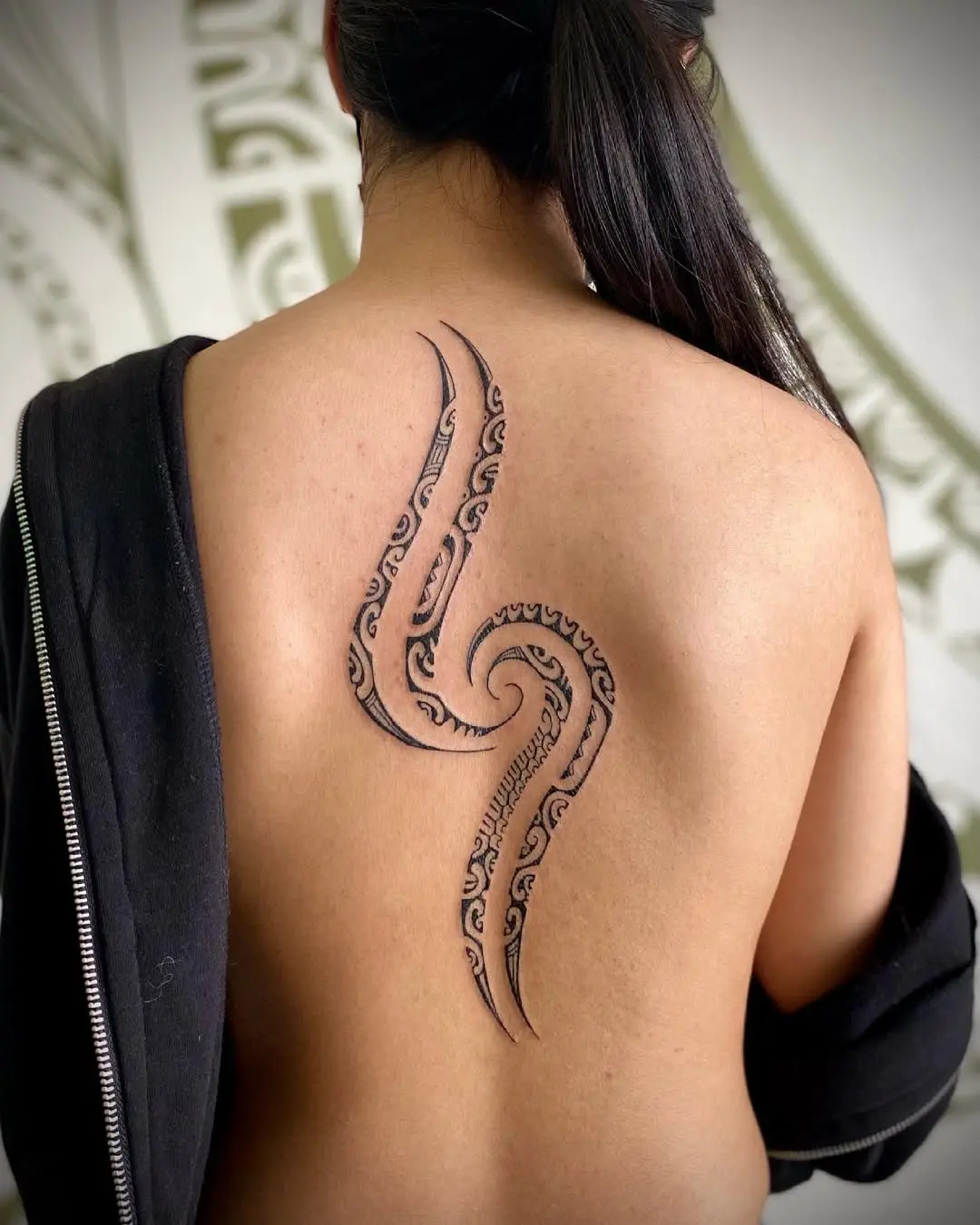 Intricate spine tattoo with an octopus design