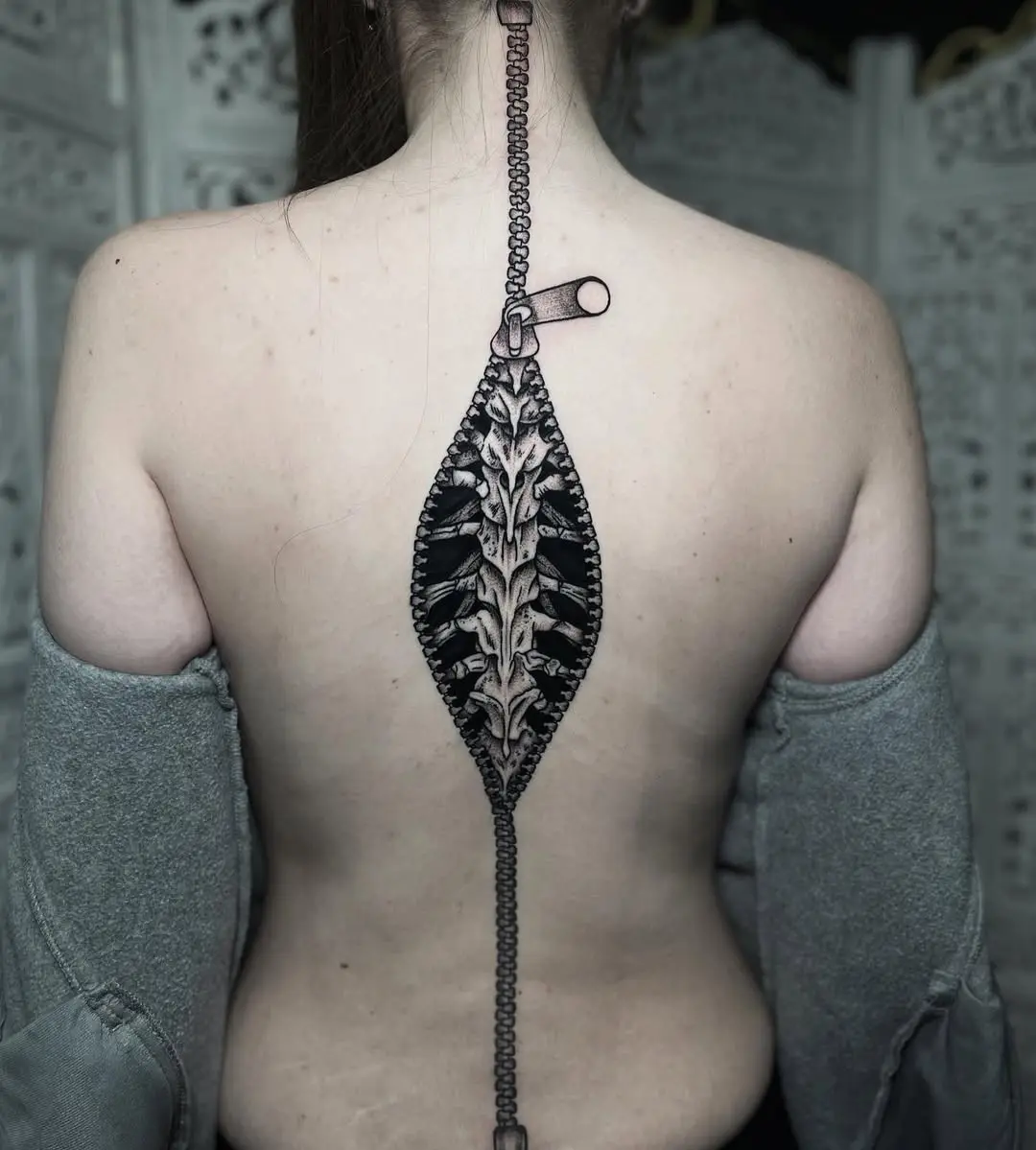 Intricate spine tattoo with zipper design