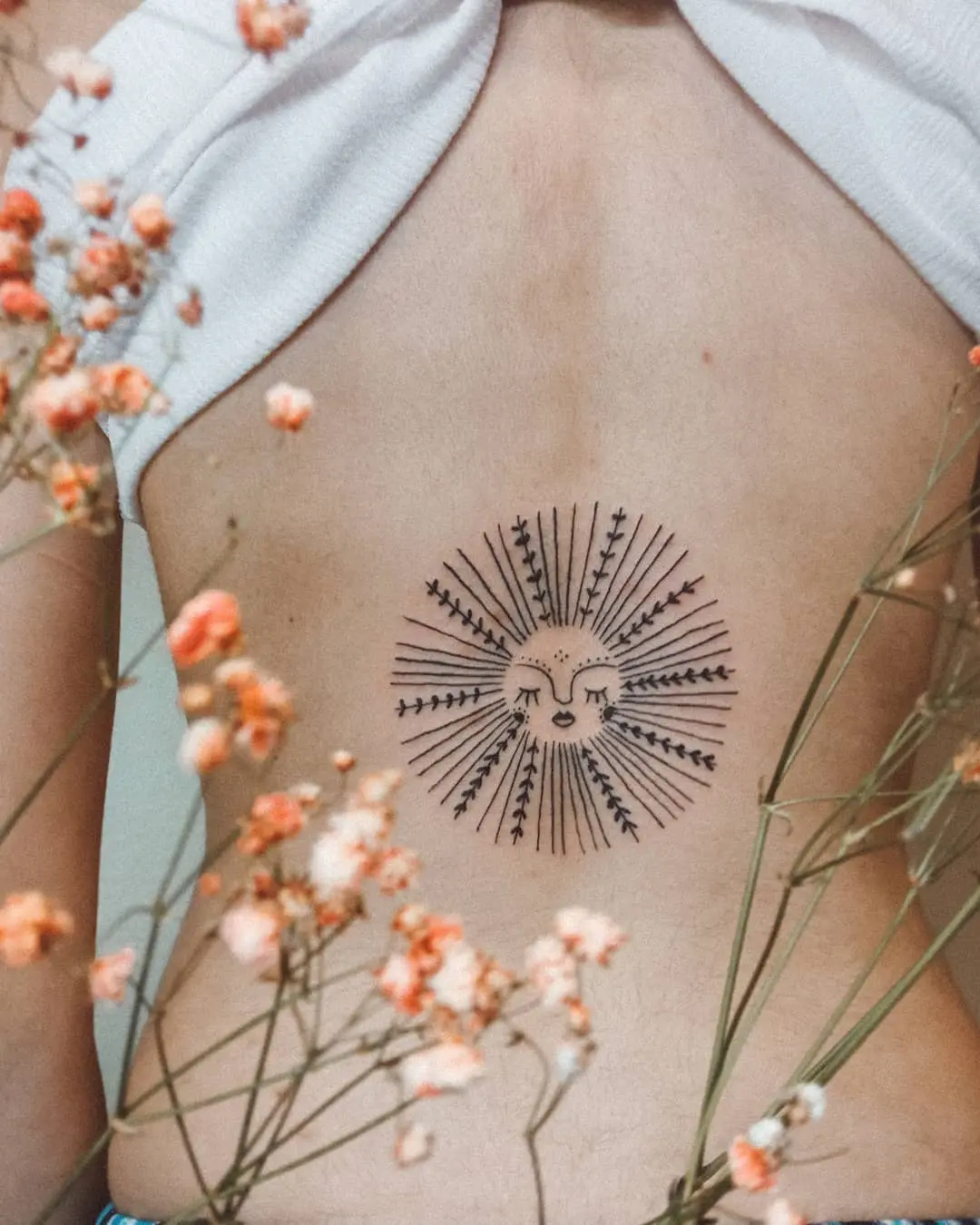 Radiant sunburst tattoo symbolizing personal growth