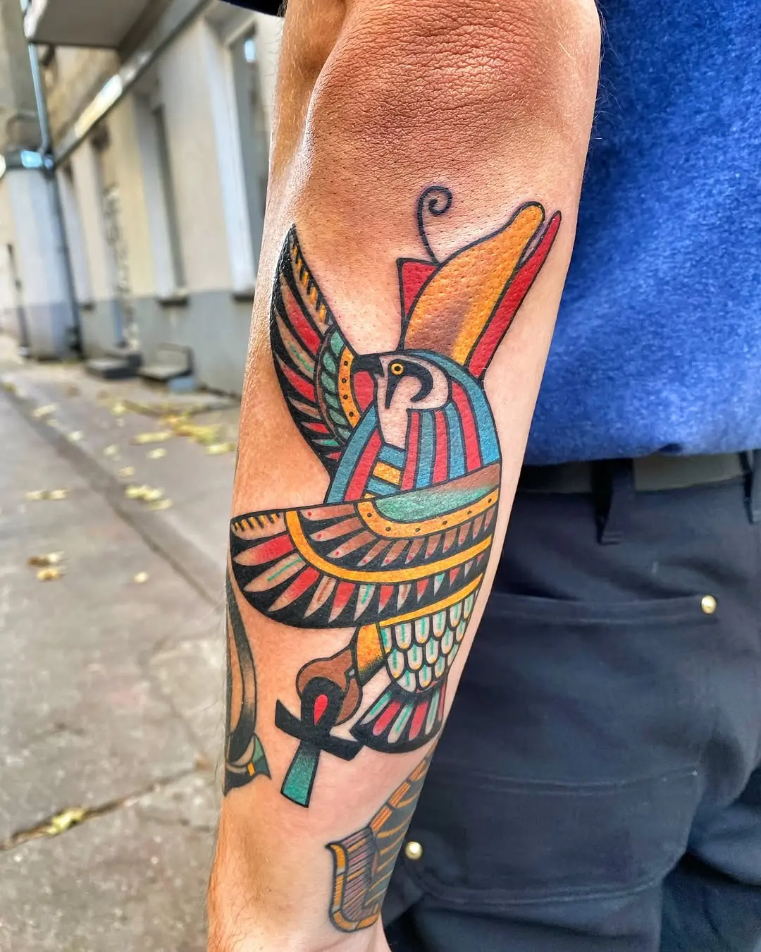 Colorful Egyptian-inspired tattoo of a bird