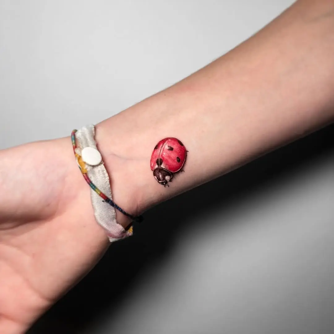 Charming ladybug tattoo on a wrist
