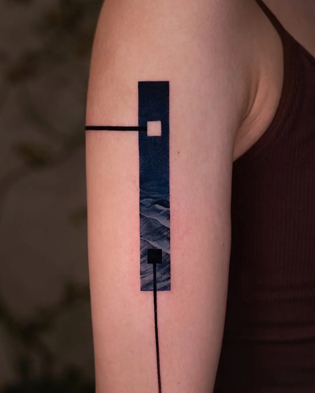 Geometric landscape tattoo on the arm