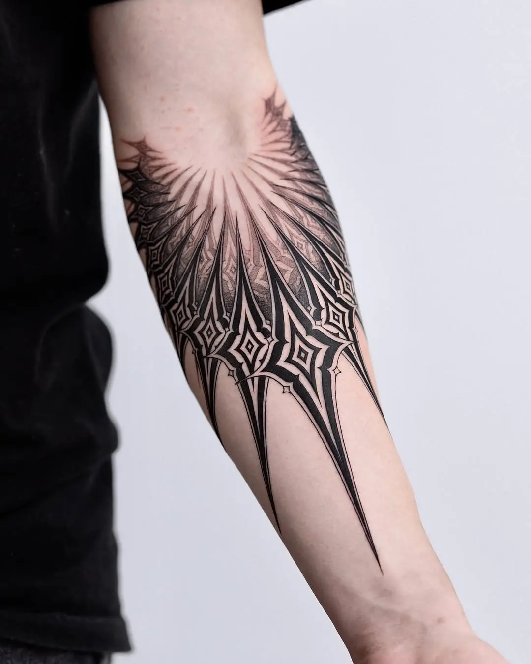 Stunning geometric black ink forearm tattoo design