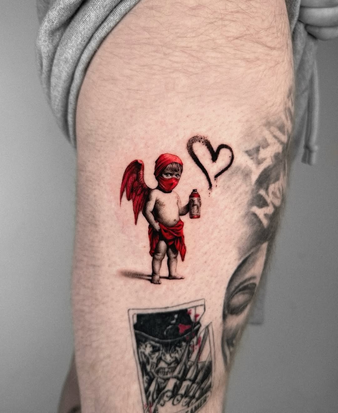 Whimsical cherubic tattoo with a playful twist