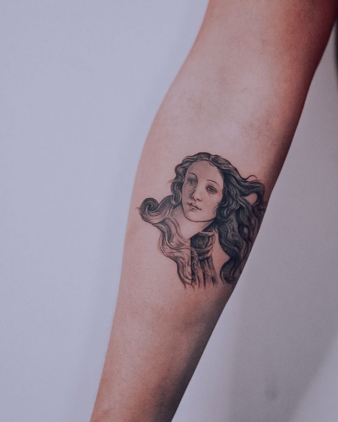 Elegant portrait tattoo on a graceful forearm