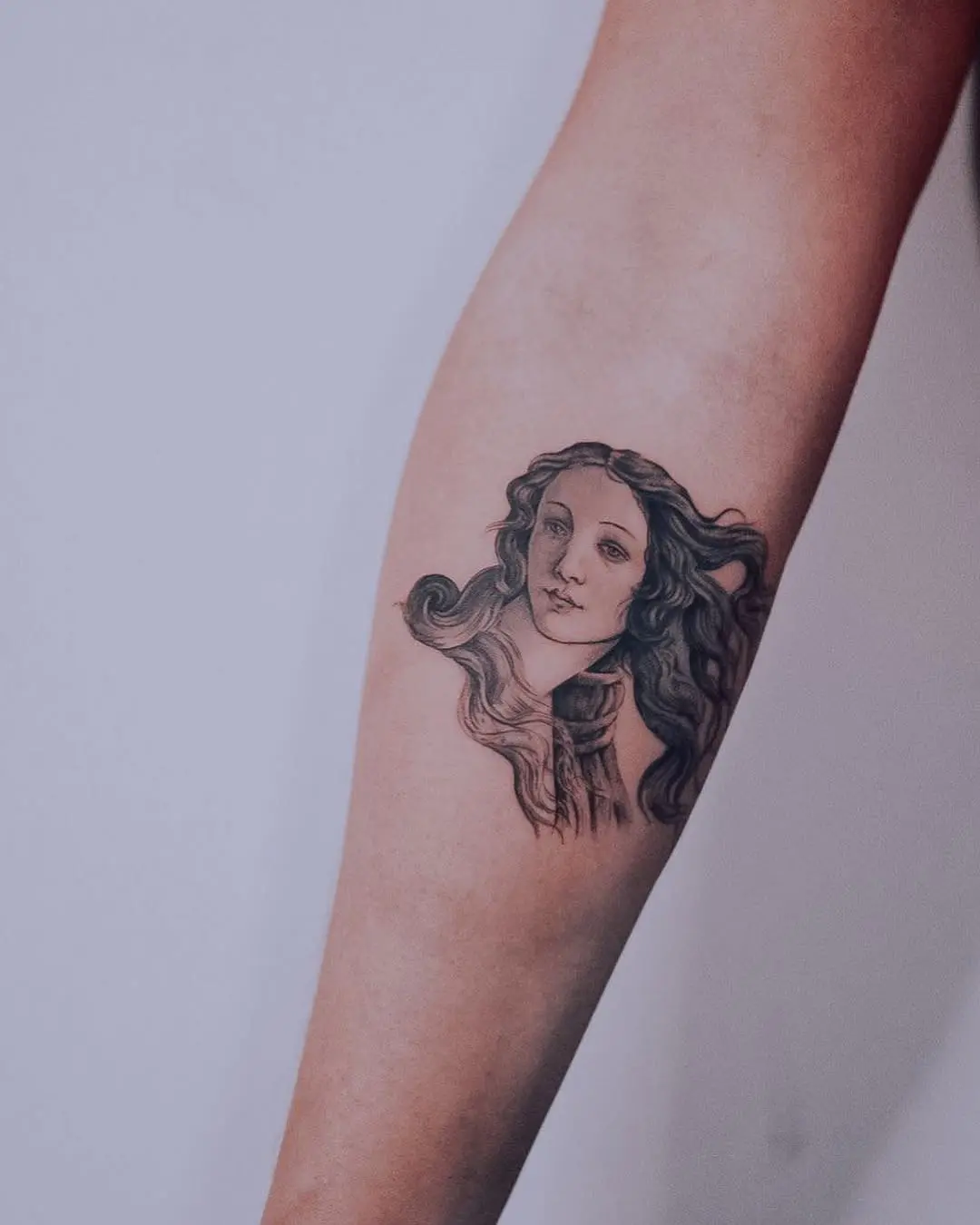Elegant portrait tattoo on a graceful forearm