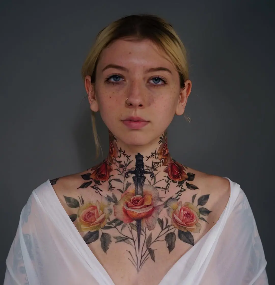 Stunning floral and dagger neck tattoo art