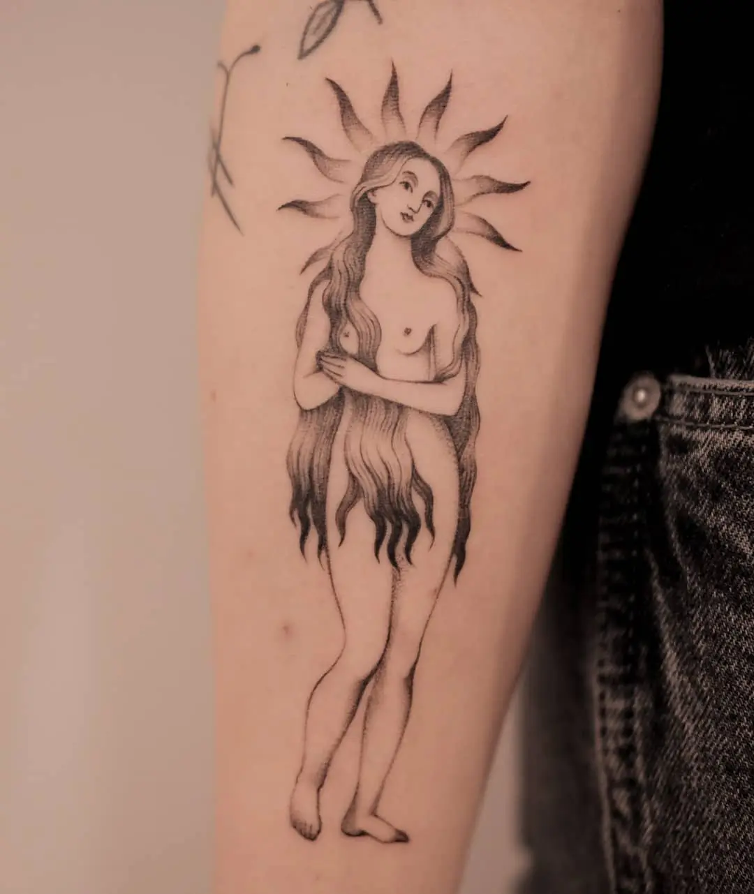Captivating sun goddess tattoo in black ink