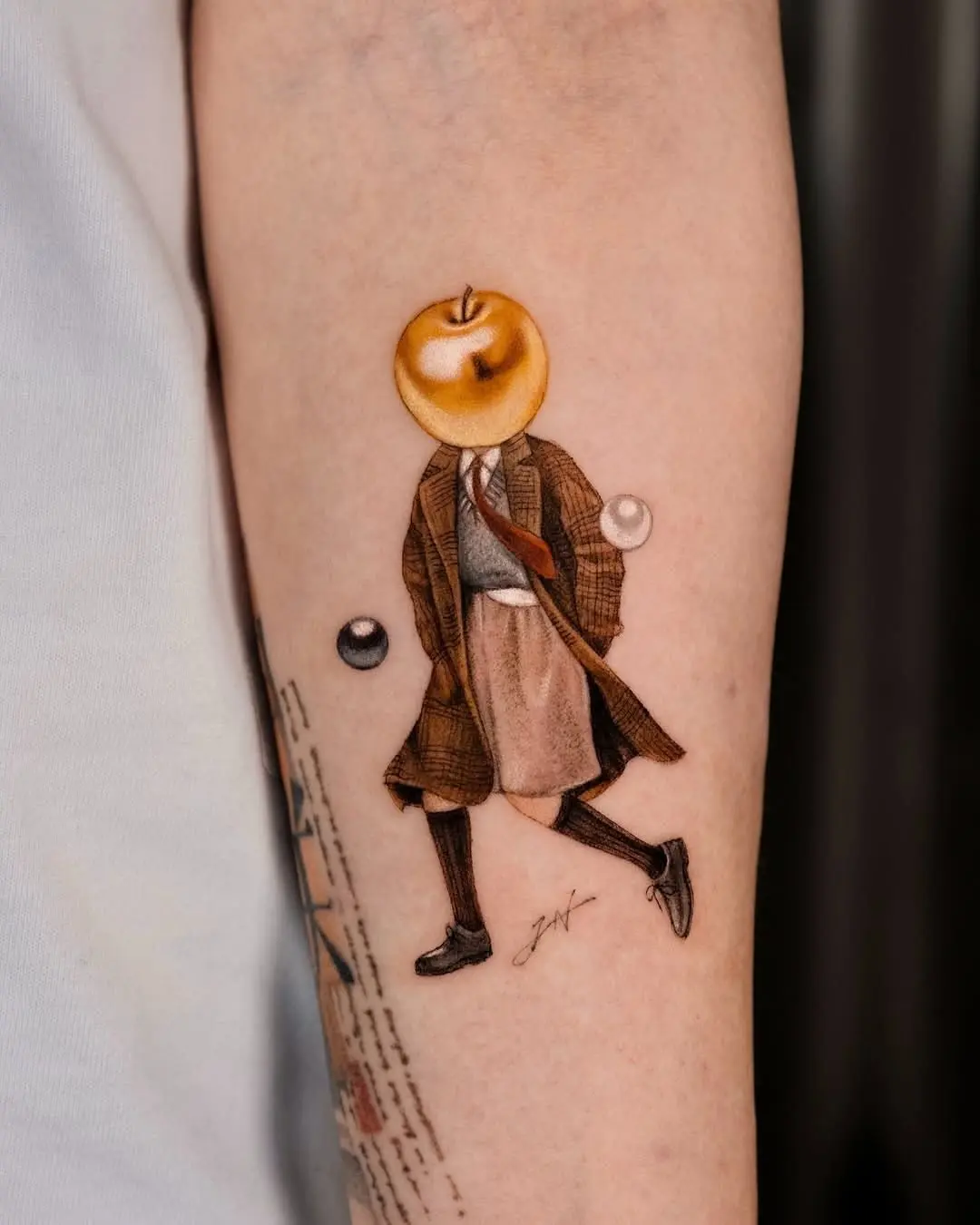 Whimsical tattoo of a man with an apple head