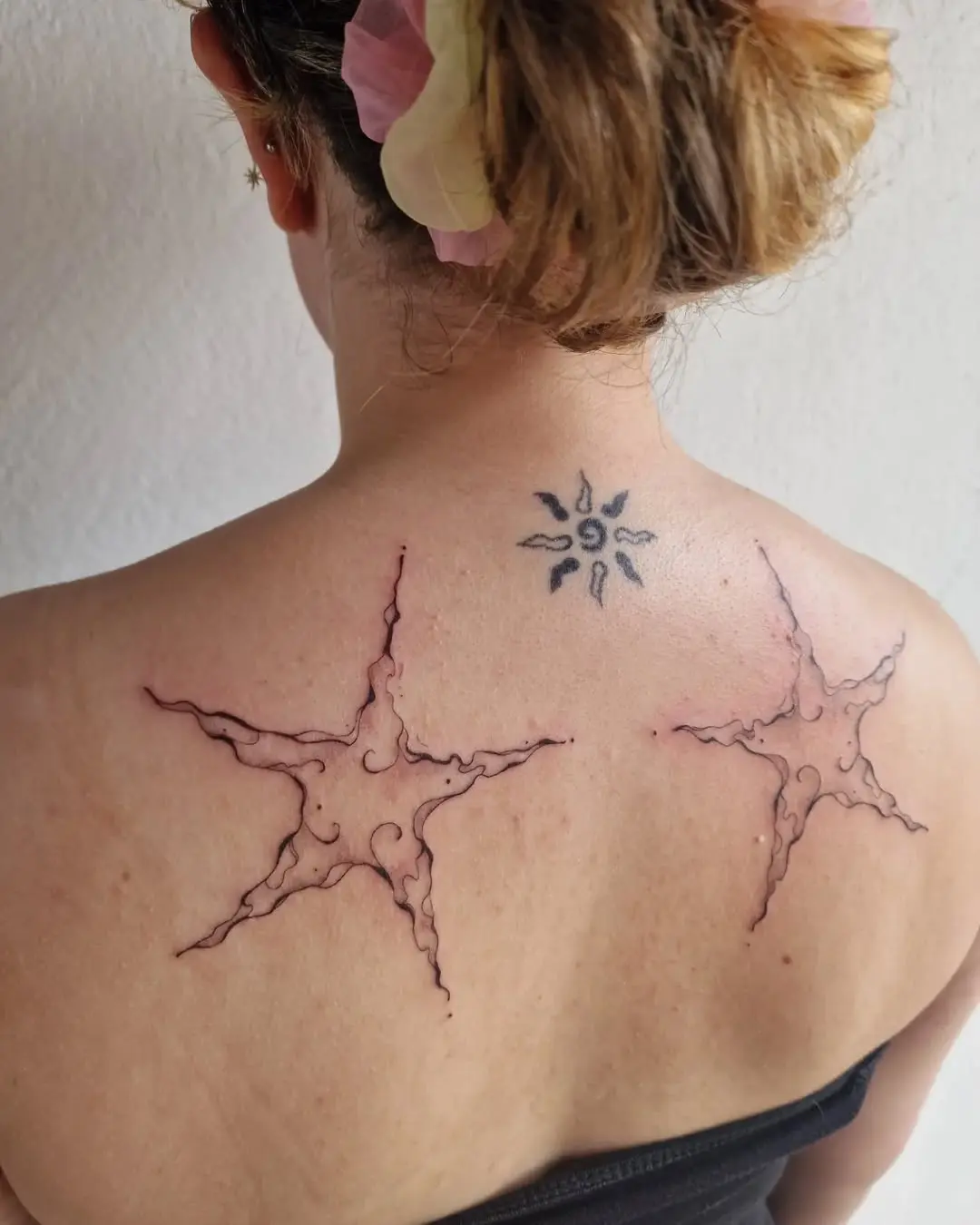 Intricate star tattoos with playful ink details