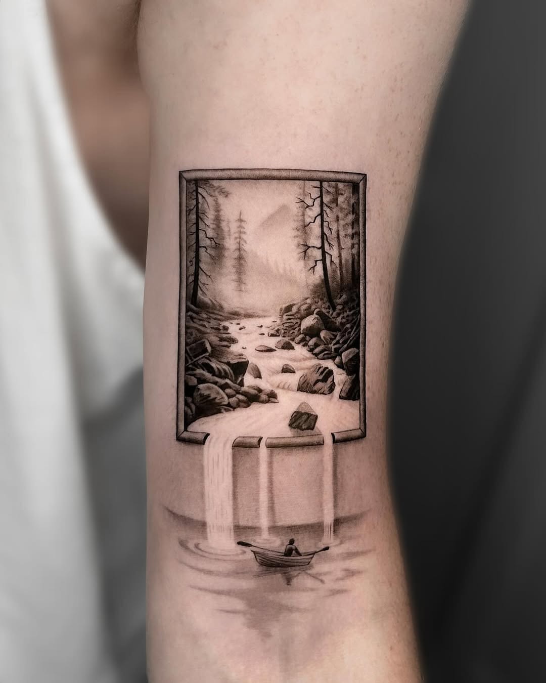 Framed waterfall tattoo with serene boat scene
