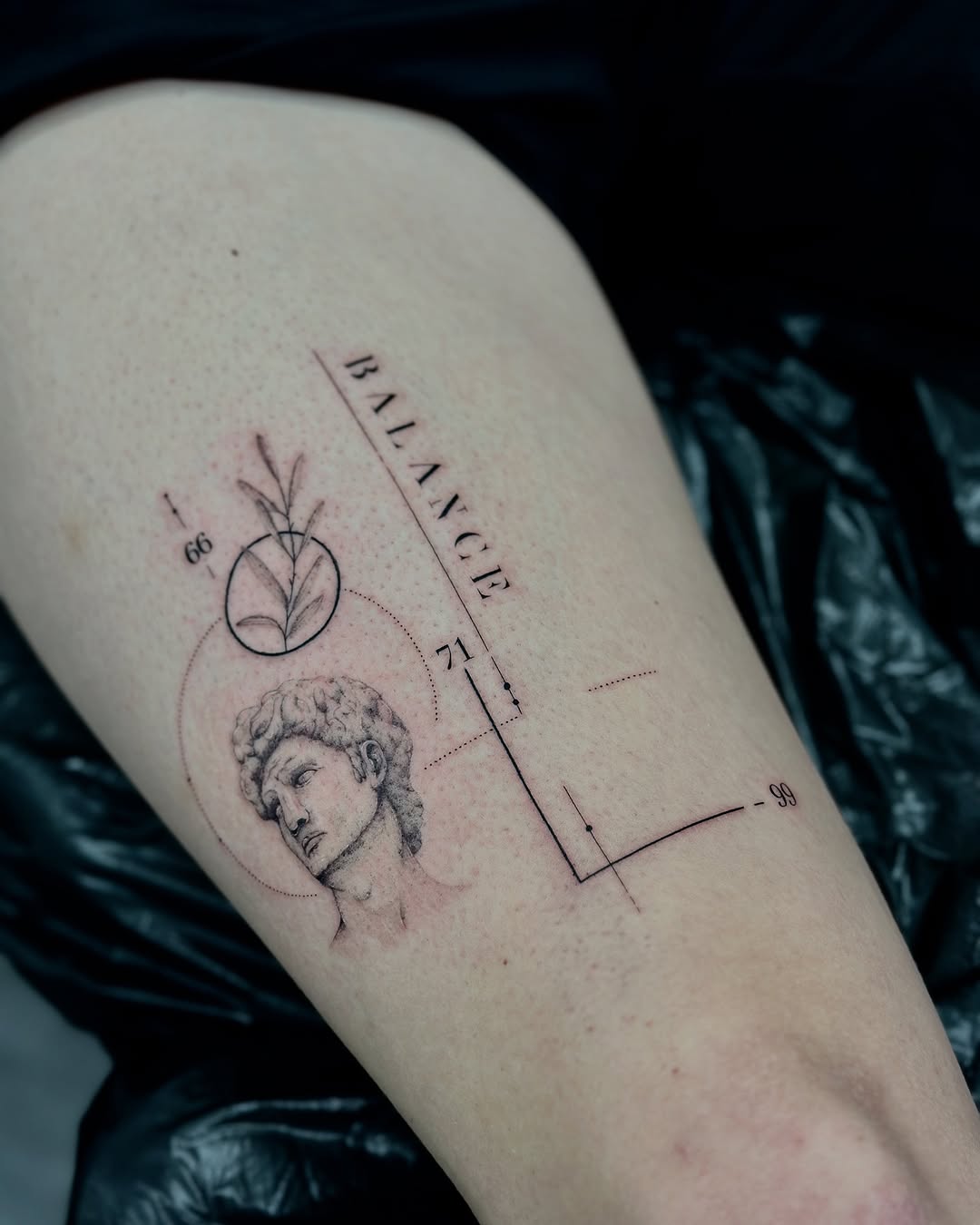 Elegant Balance Tattoo Featuring Classical Imagery