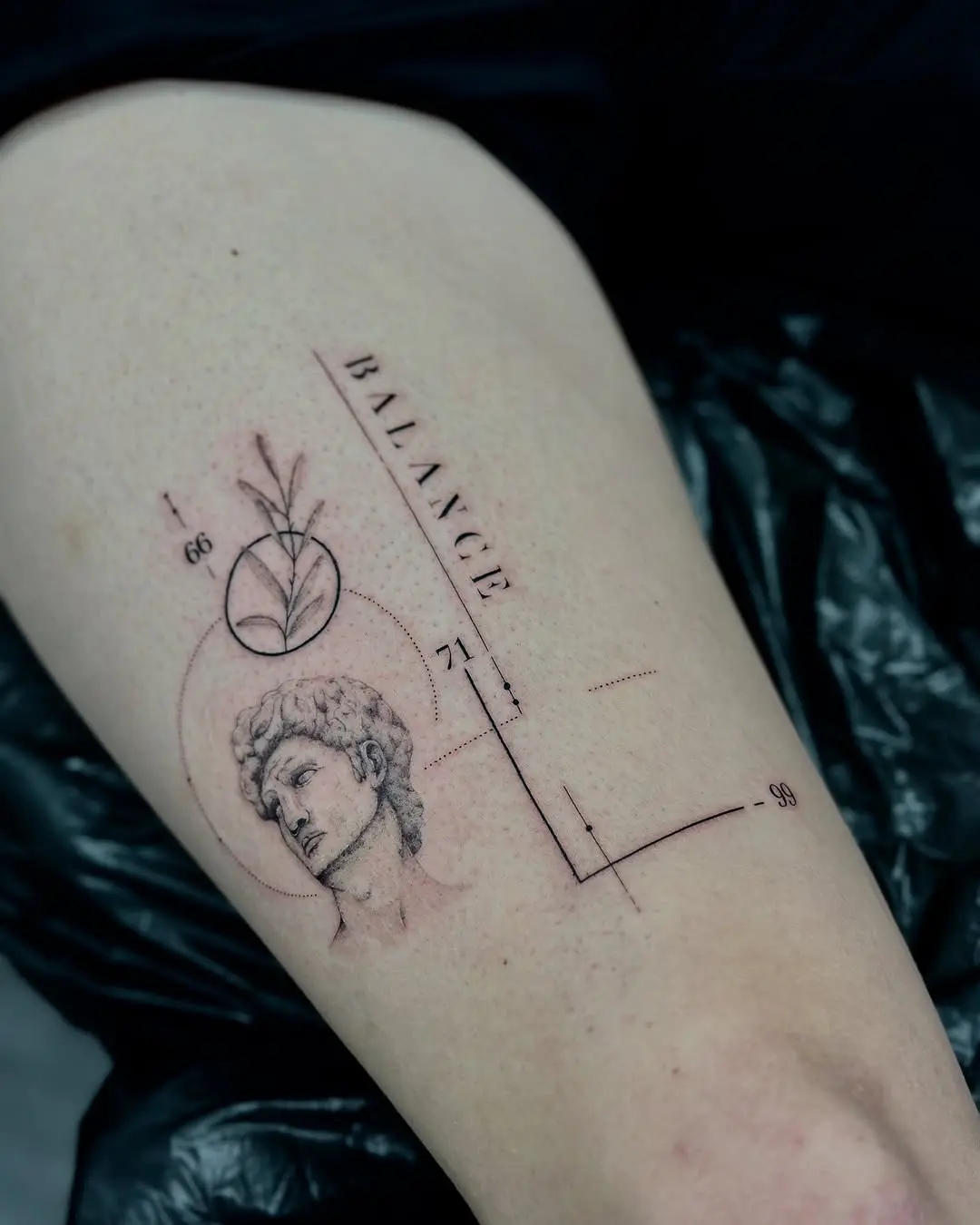 Elegant Balance Tattoo Featuring Classical Imagery