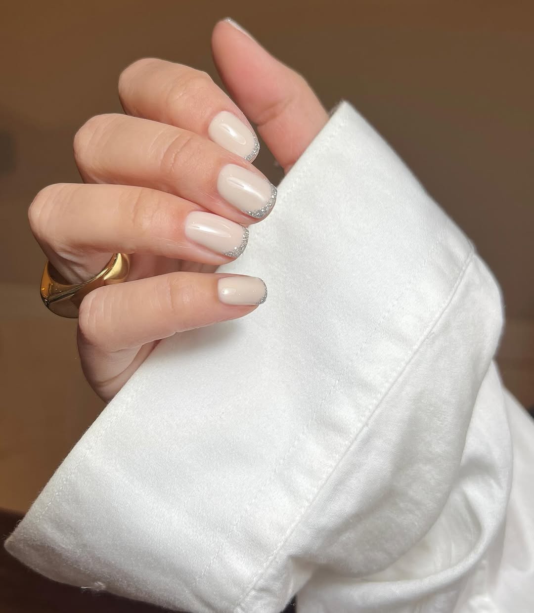 Chic beige nails with sparkling silver accents