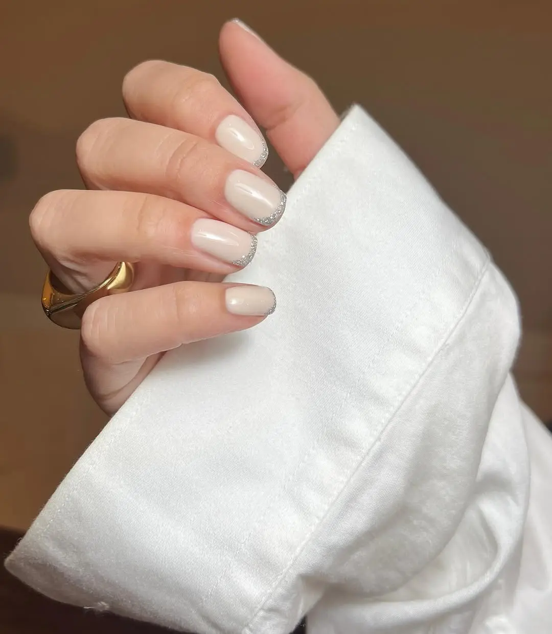 Chic beige nails with sparkling silver accents
