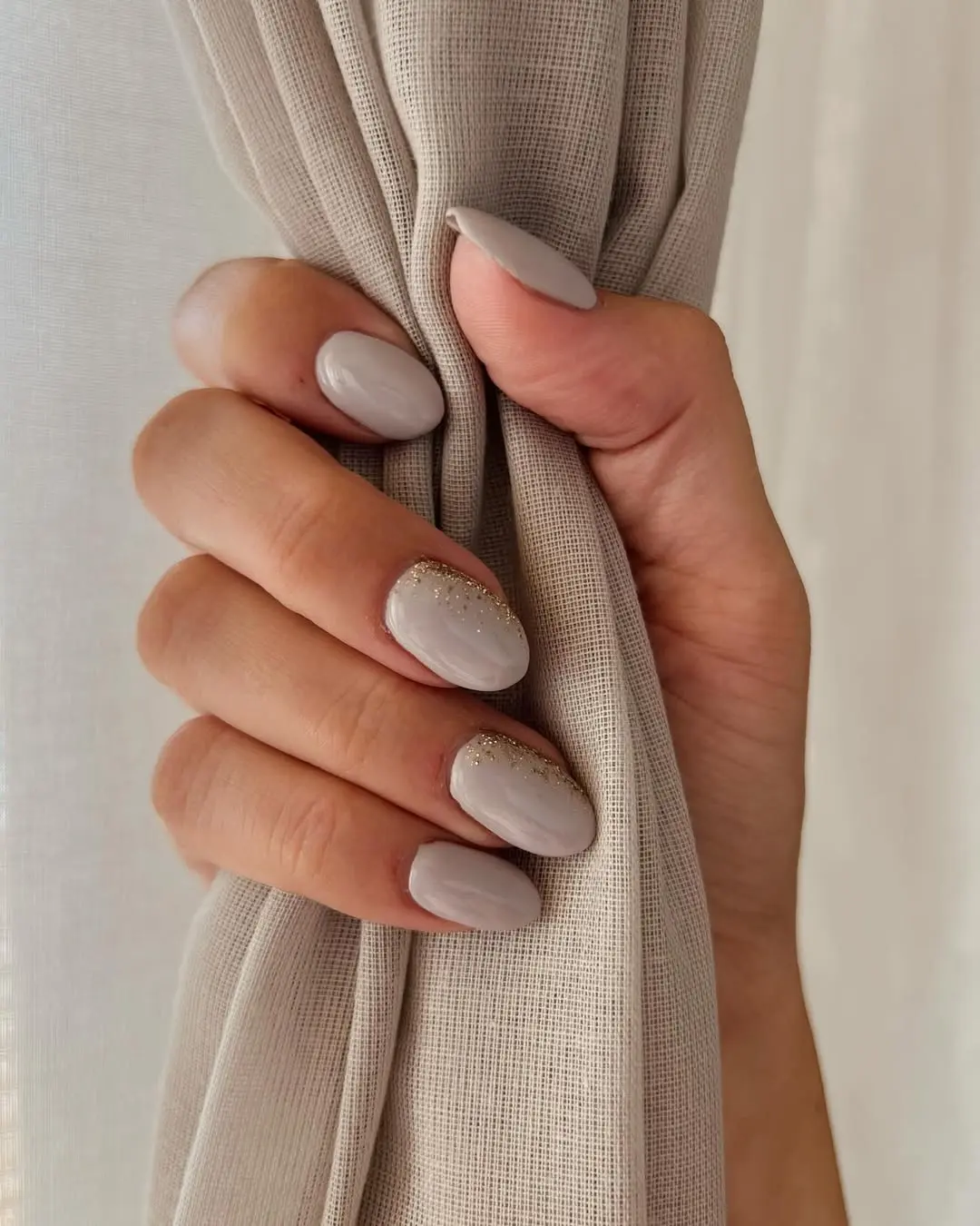 Sophisticated beige nails with glitter accents
