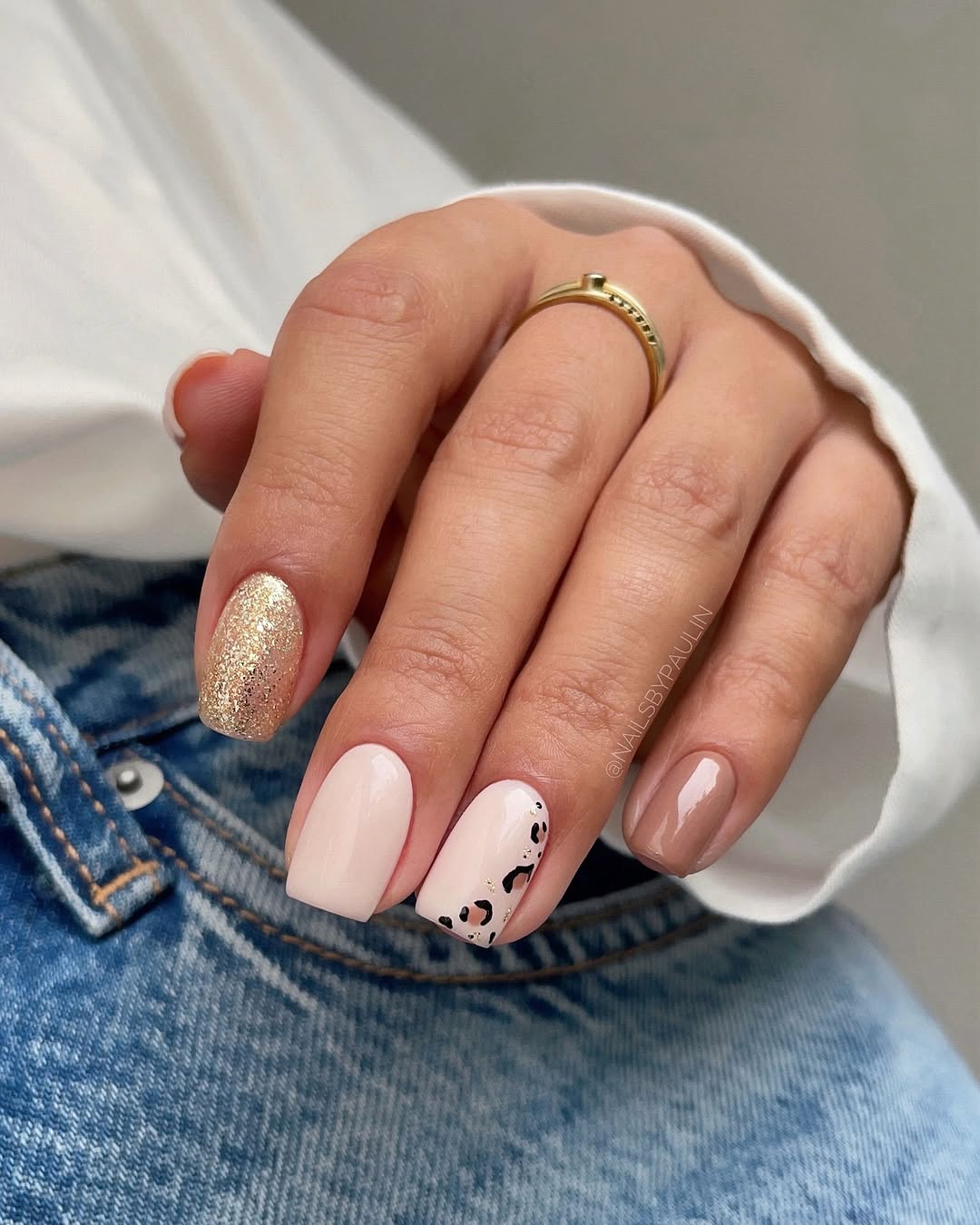 Stylish beige nails with elegant gold accents