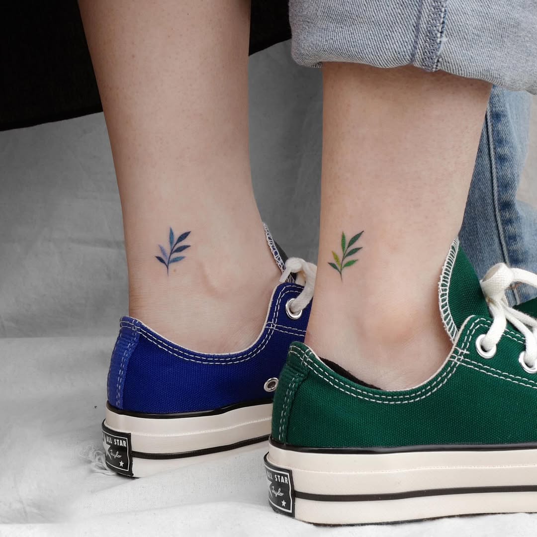 Simple leaf tattoos on matching sneakers.